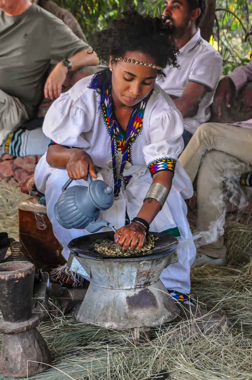 Grinding coffee beans with mortar and pestle